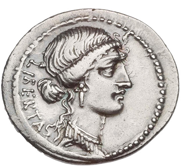 A coin showing a woman in profile with her wavy hair in a bun.